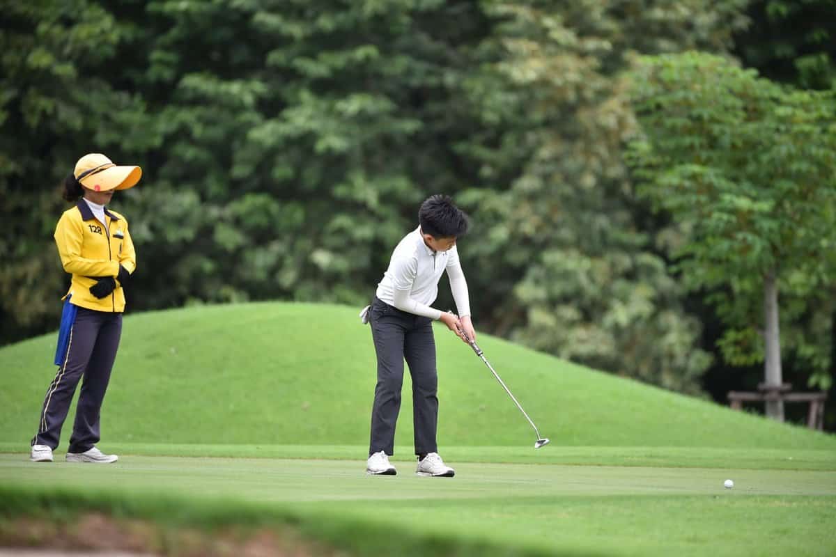 A golfer playing at a golf course near the airport.